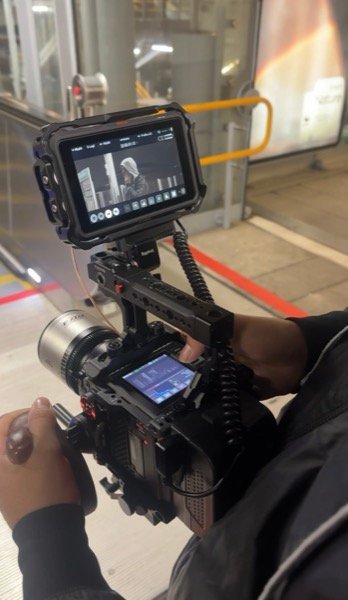 Operating cinema camera with external monitor on industrial location shoot