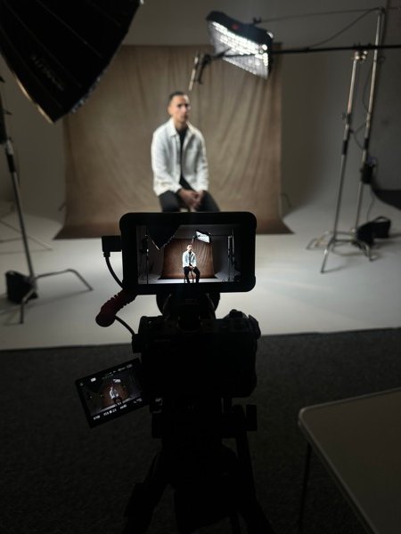 Studio portrait shoot with professional lighting and camera setup