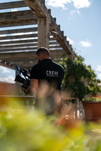 White Box Media crew member filming outdoors with cinema camera