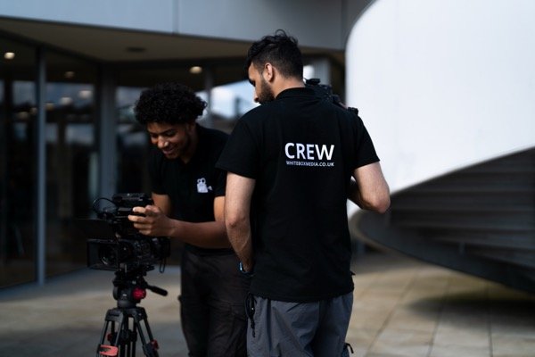 White Box Media crew reviewing camera settings on location